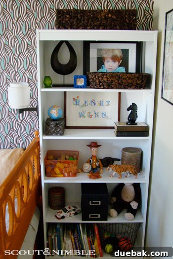 Wallpaper Wonders: A Big Boy's Stylish Sanctuary 4 Close-up of a colorful, organized shelf with books, toys, and a creative station in a child's bedroom
