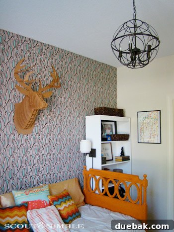 Wallpaper Wonders: A Big Boy's Stylish Sanctuary 5 A creative corner in the 'big boy' room with a desk, art supplies, and colorful decorations