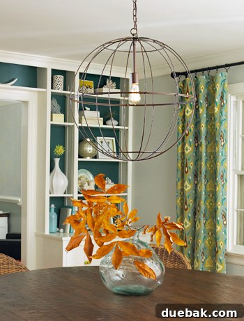 The large wire globe lantern chandelier in a home, showing its scale and design.