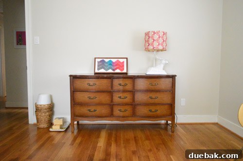 The newly placed secondhand dresser in Clara's room, positioned on the left wall as you enter, with the daybed visible on the opposite wall.
