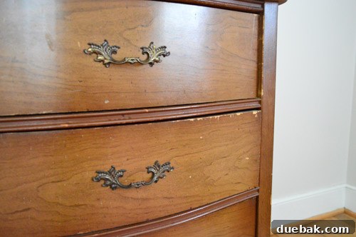 Close-up detail of the dresser's surface, revealing minor imperfections and areas that will require refinishing or painting.