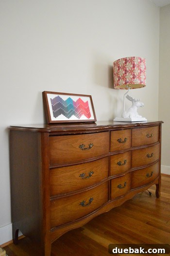 The white ceramic moose lamp, with its DIY fabric shade, sitting on a side table in Clara's partially decorated room.