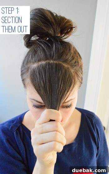 Woman pulling dry hair forward for DIY bang haircut
