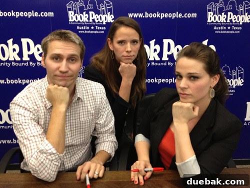 Audrey posing with authors without smiling after dental work