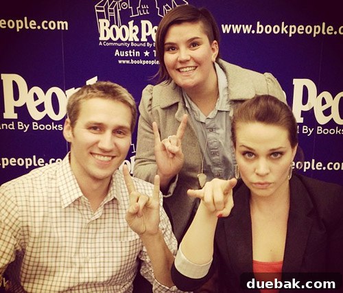 Authors and fan doing the 'Hook 'Em Horns' gesture