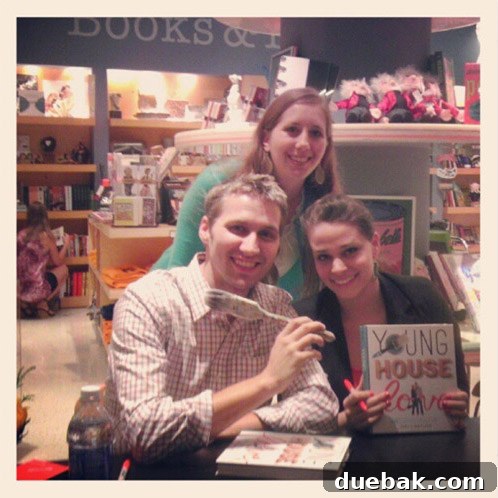 Author signing a well-used paintbrush for a fan