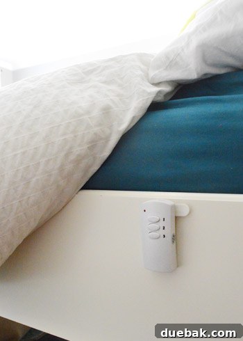 Remote control attached to bed frame with Velcro, hidden from view