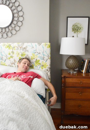 Person relaxing in bed with the remote control nearby