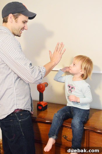 High-five moment during shelf installation