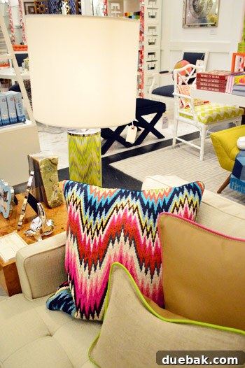 Needlepoint pillow with diverse colors, expertly layered with two neon-piped pillows for a modern, eclectic look.