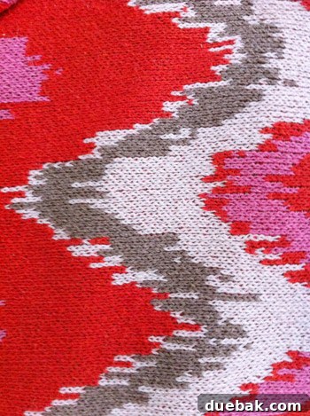 DIY No Sew Ikat Curtains for Playful Kids Spaces 2 Close-up of a hand reaching towards a display of colorful fabrics in a fabric store