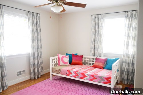 DIY No Sew Ikat Curtains for Playful Kids Spaces 11 A newly hung navy and white patterned curtain in Clara's room, showing part of the daybed