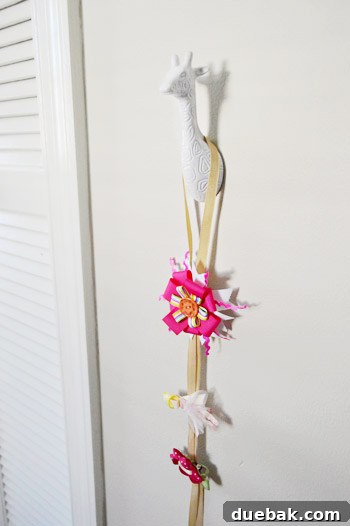 Giraffe-shaped hook named Bamma holding hair bows