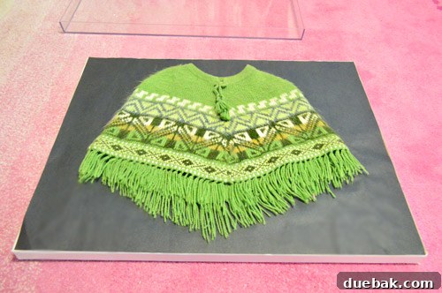 Peruvian poncho carefully laid on the charcoal paper background within the frame