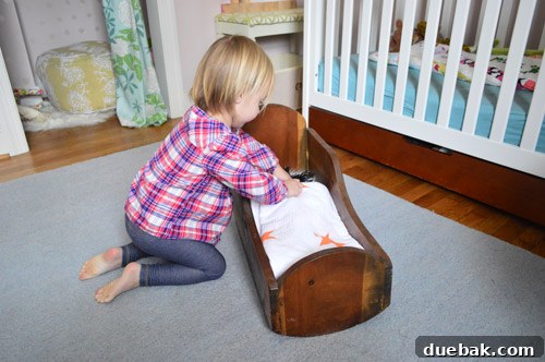 Macklemore's Thrifty Style Showdown 9 A doll tucked into a blanket in a wooden cradle
