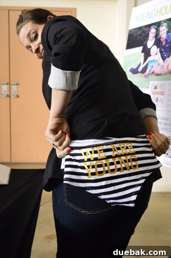Sherry proudly holding up a pair of gifted underwear with gold lettering, a humorous fan gift.