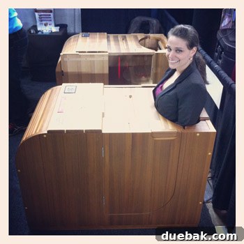 Sherry trying out a peculiar dry hot tub / steam-free sauna contraption at the Home Show.