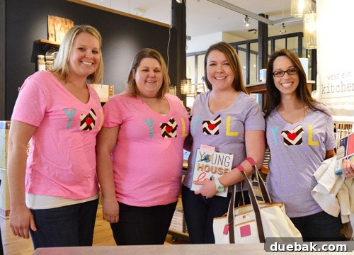 Dedicated fans from Los Angeles wearing DIY shirts with a house and heart design, posing with the authors.