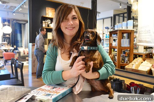 The authors happily petting two canine visitors at the Palo Alto book signing event.