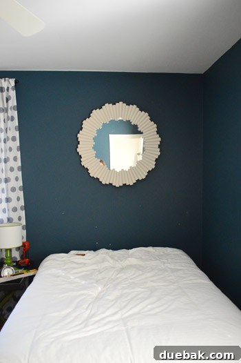 Mirror being hung in guest room