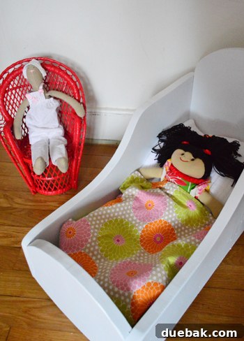 Wooden doll cradle painted white