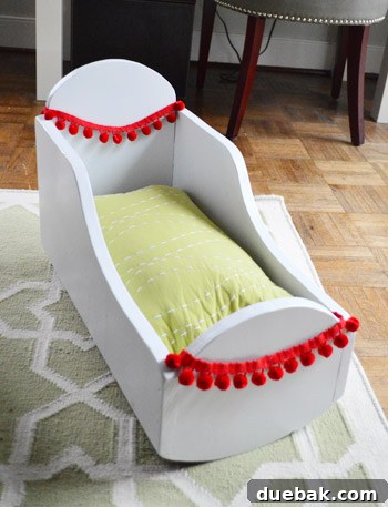 Lumbar pillow used as a doll mattress in the cradle