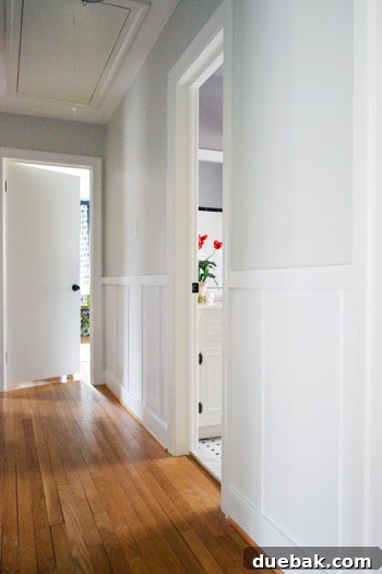 Bright and updated hallway featuring white board and batten
