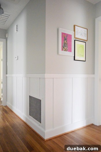 Finished board and batten hallway with gray paint above, ready for decor