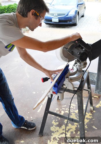 Mastering Crown Molding Installation 15 John using miter saw to make cut on crown molding