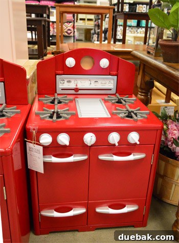 Vibrant red play kitchen with a missing dial, found at Pottery Barn Outlet