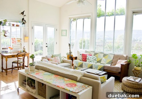 Crashing into Quaintness: The Vine-Covered Home 5 Sunny living room with handmade quilts and thrifted furniture
