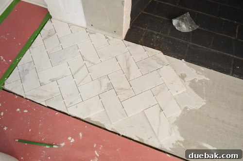Your Guide to a Stunning Marble Herringbone Fireplace 15 Fireplace hearth tiling in progress