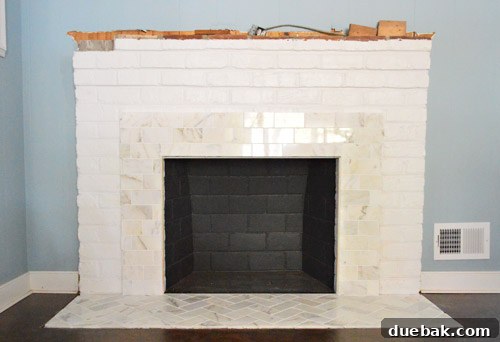 Marble subway tile hearth and lower fireplace surround before building the frame