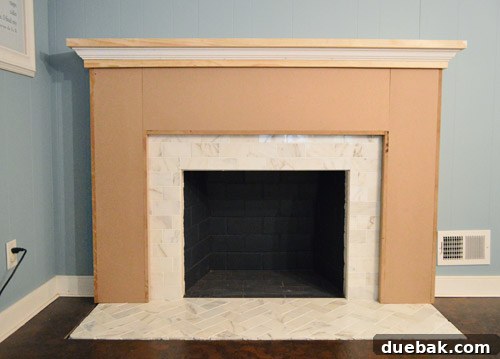 The fireplace frame with mantel and crown molding prep completed