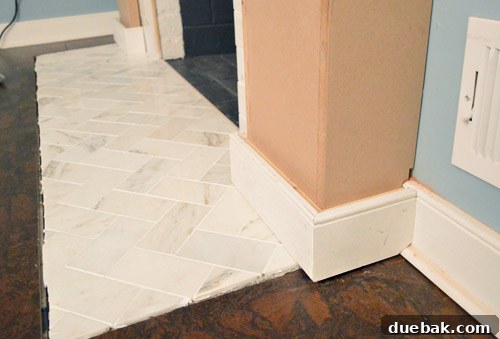 Installing baseboard with a hidden 1x2 shim to create depth