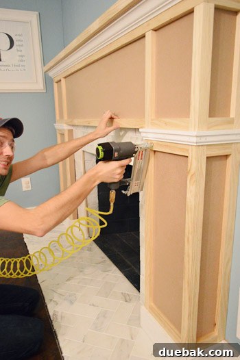 Adding a decorative trim piece to break up the box panels on the fireplace frame