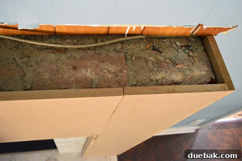 Top-down view of the MDF frame fitting around the old, unsightly brick fireplace
