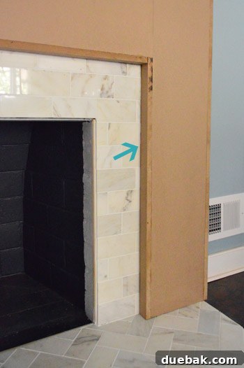 Detailed view of adding thin MDF shims to fill a gap between the frame and tile