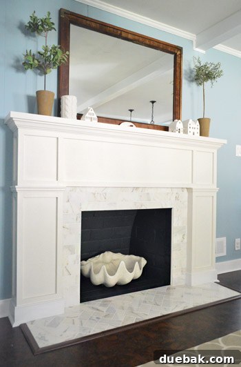 Our $200 Marble Fireplace Glow-Up 5 The fully completed fireplace makeover with a sleek white mantel and marble subway tile