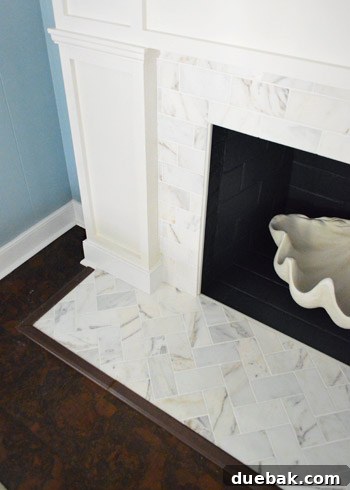 Our $200 Marble Fireplace Glow-Up 9 Another perspective of the elegant marble tiled fireplace with the white built-in mantel