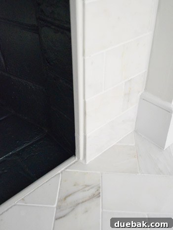 Our $200 Marble Fireplace Glow-Up 10 Close-up showing the detail of the trim used to conceal the cement board edge around the firebox