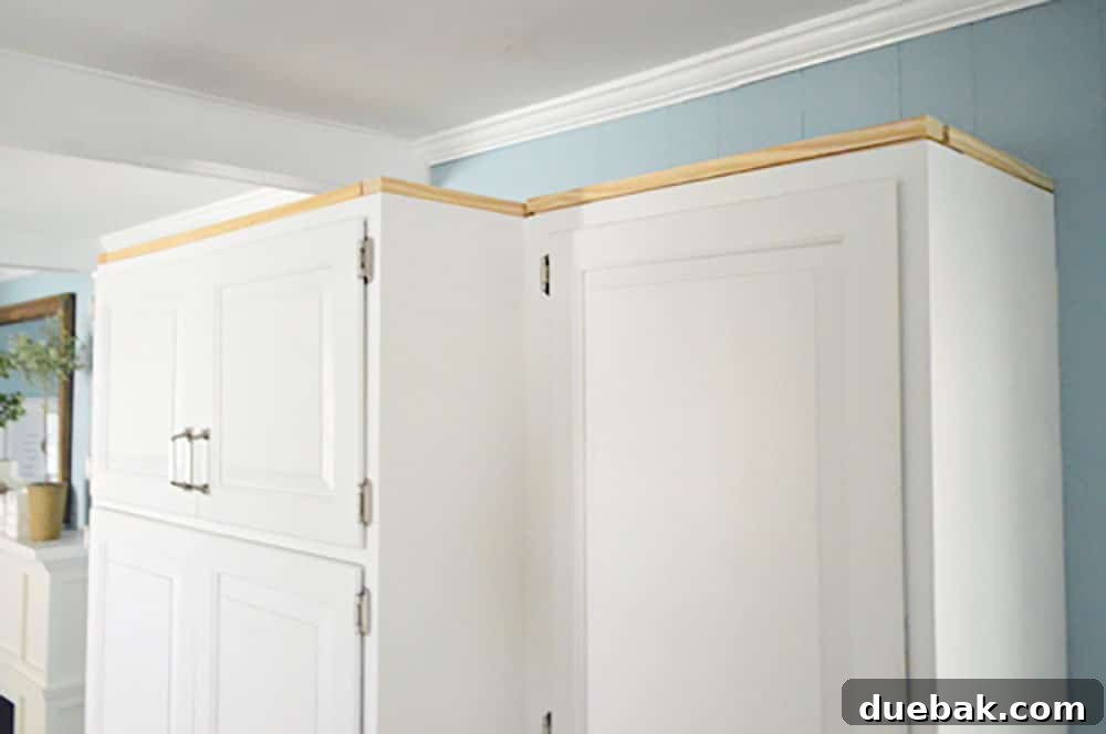 Transform Your Cabinets with Elegant Crown Molding 7 Scrap wood nailed along perimeter of upper cabinet in kitchen