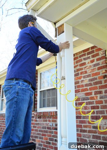 Refreshing Your Porch: Taking Down Scalloped Trim and Repairing Columns 10 An existing porch column, partially boxed out, with pre-primed pine boards ready for installation.