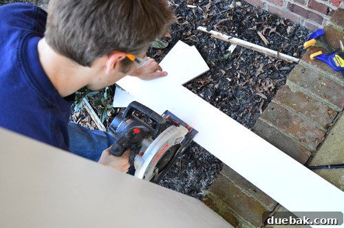Refreshing Your Porch: Taking Down Scalloped Trim and Repairing Columns 11 Using a circular saw to precisely trim pre-primed pine boards to length for the column boxing project.