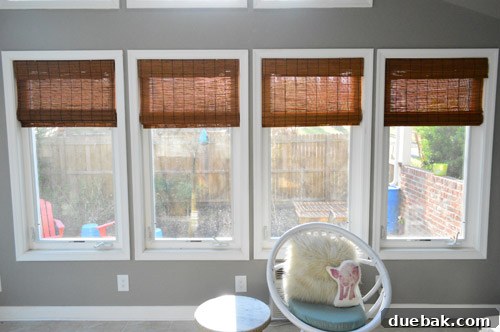 Combination of outdoor fence and bamboo blinds for sunroom privacy