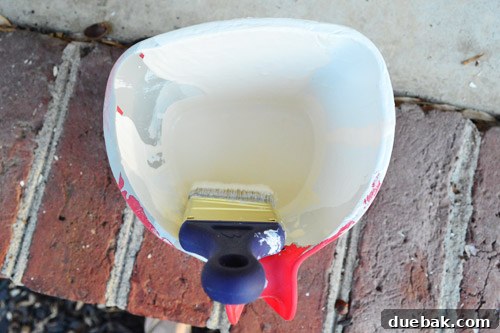 Transforming Curved Porch Columns with a Boxed Design 6 Applying paint to the newly caulked porch columns