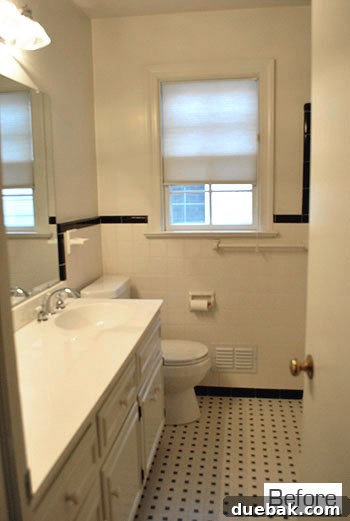 Updated hall bathroom with new light fixture and mirror frame