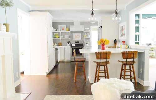 Kitchen showing open shelves and tiled backsplash