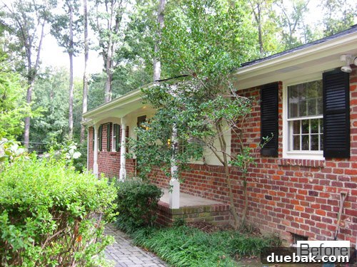Renovated front porch with new furniture and plants