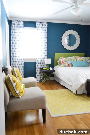 Guest bedroom with crown molding and large mirror